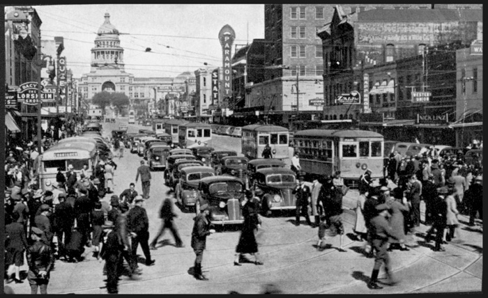 Austin Street Ry. cars lined up in heavy traffic along Congress Avenue looking toward the capitol building. Undated. 