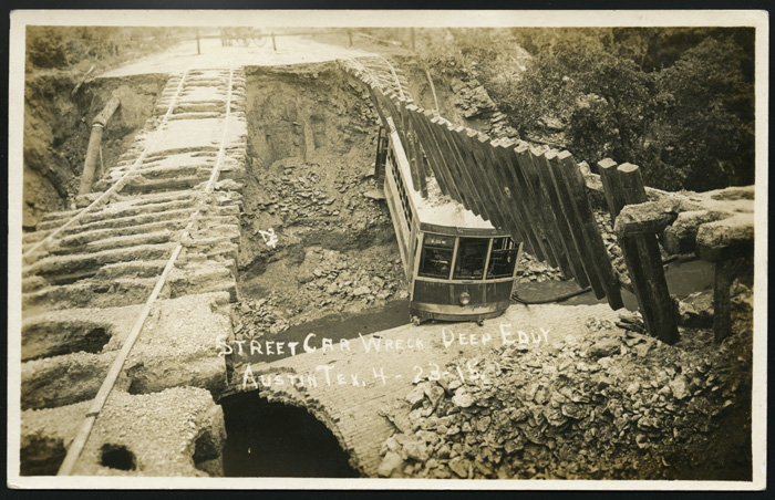 Austin Street Ry. bridge and streetcar destroyed by flood waters on April 22, 1915. 